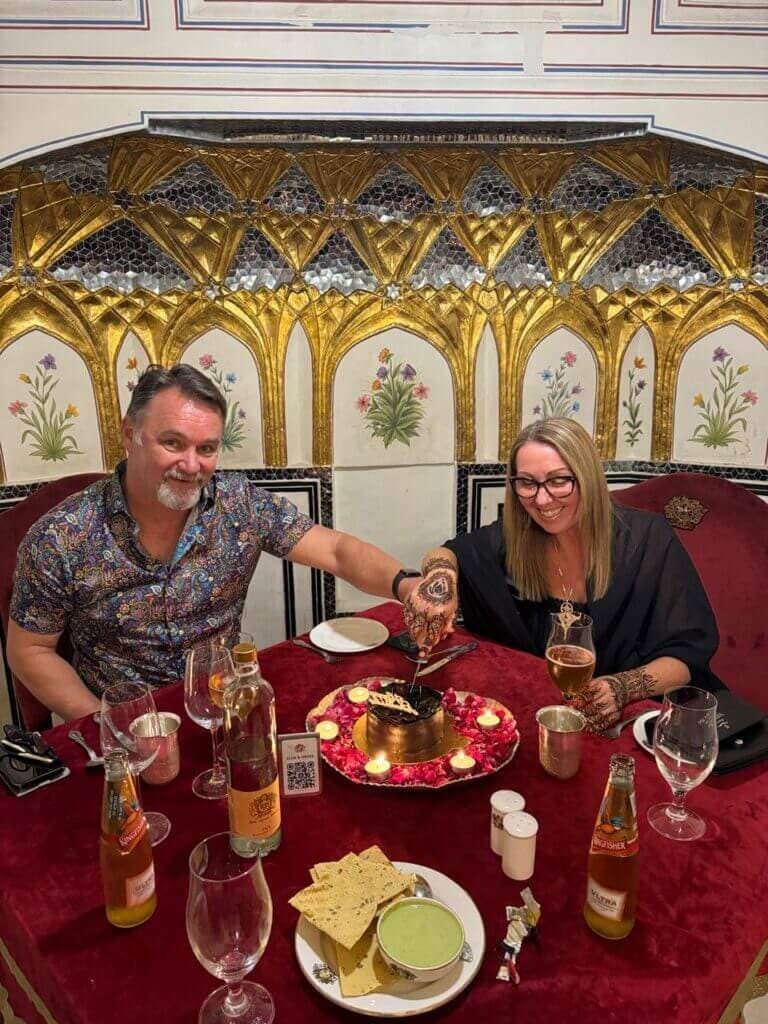 Guests celebrating with a private cake at an ornately decorated restaurant