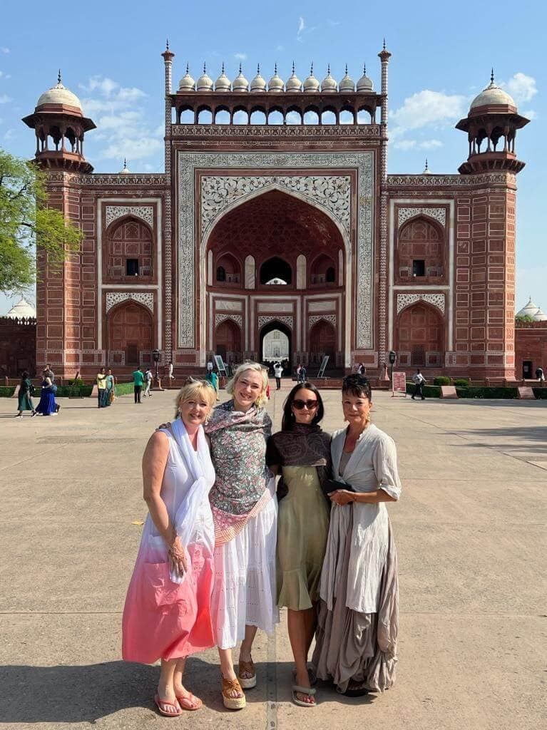 A group of guests posing in front of the Taj Mahal's Great Gate, Agra