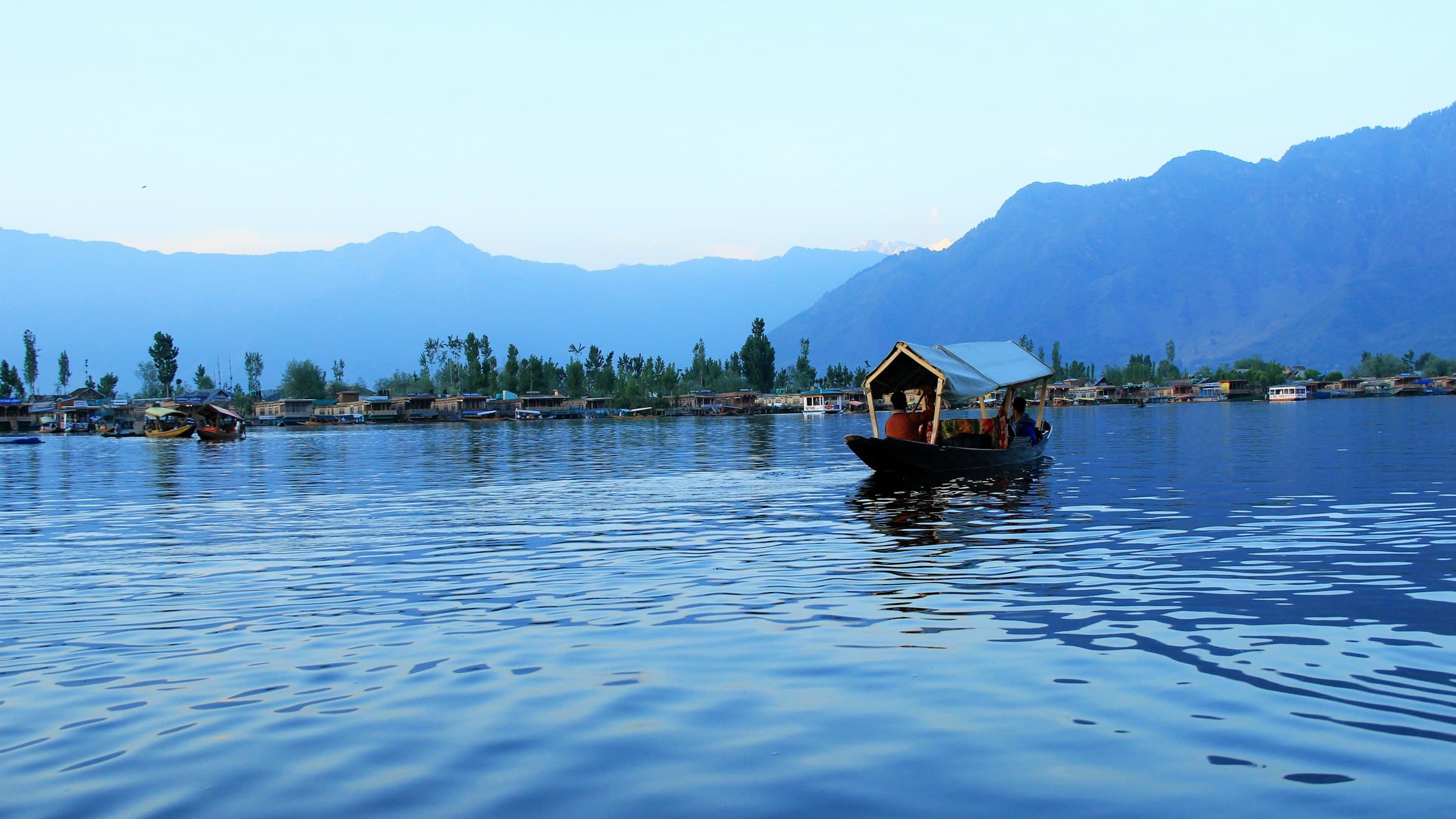 Shikara boats carrying passengers across Dal Lake in Srinagar, Kashmir