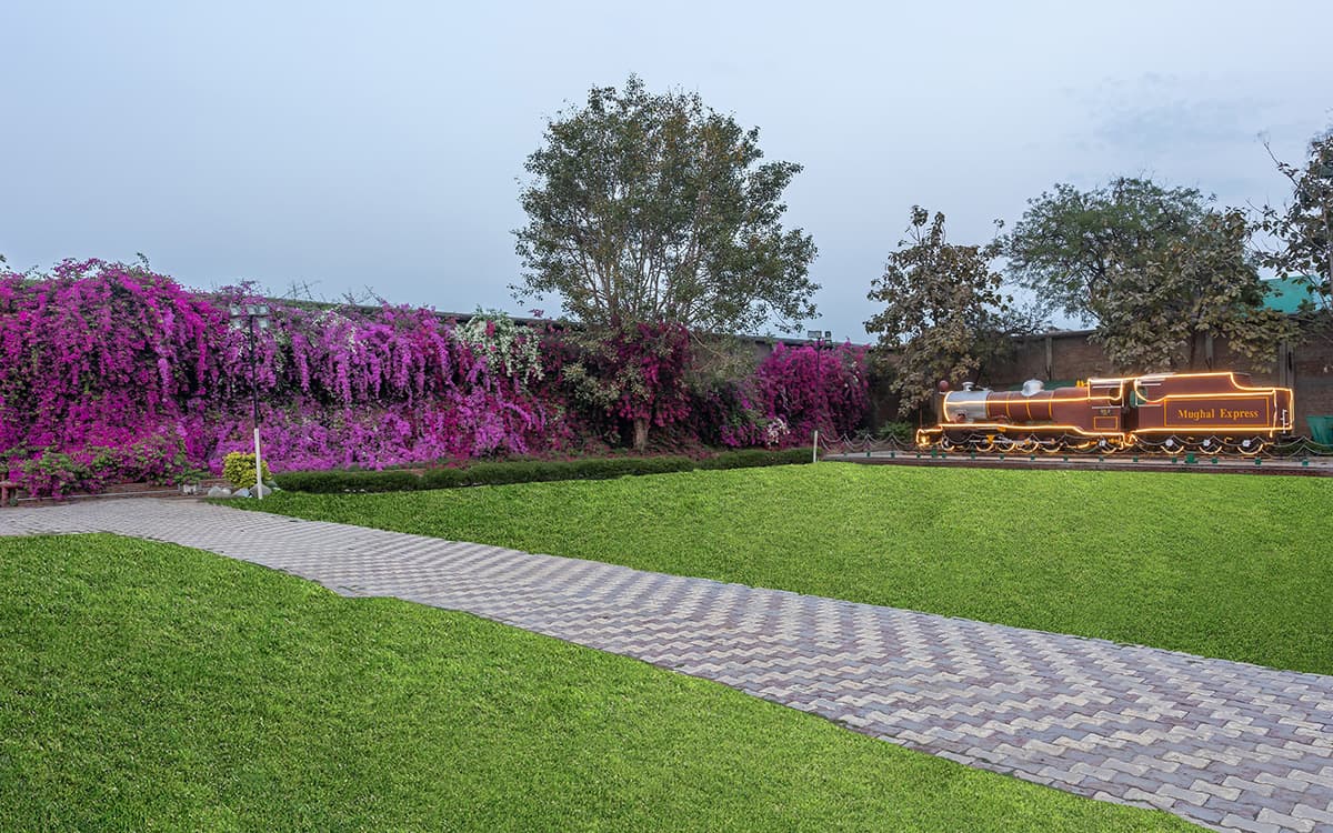 ITC Mughal's Sher Shah Suri garden courtyard with fountains and red sandstone colonnades