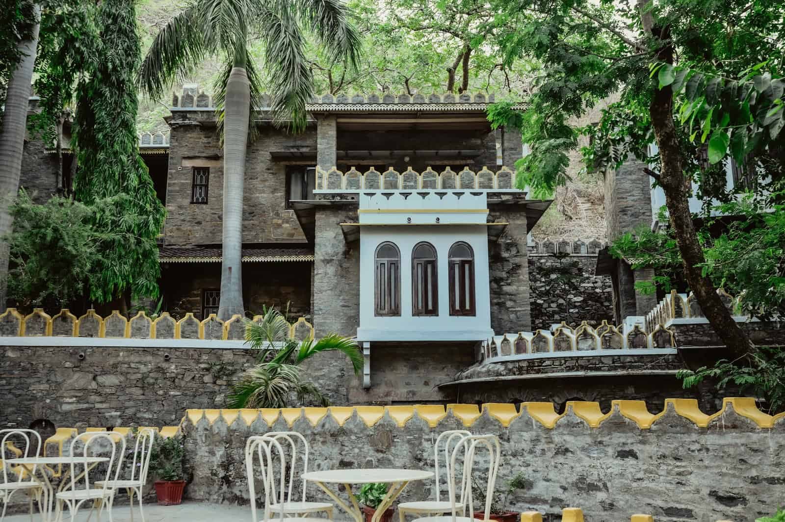 The Aodhi's stone heritage building at Kumbhalgarh, seen through the surrounding forested Aravalli hillside