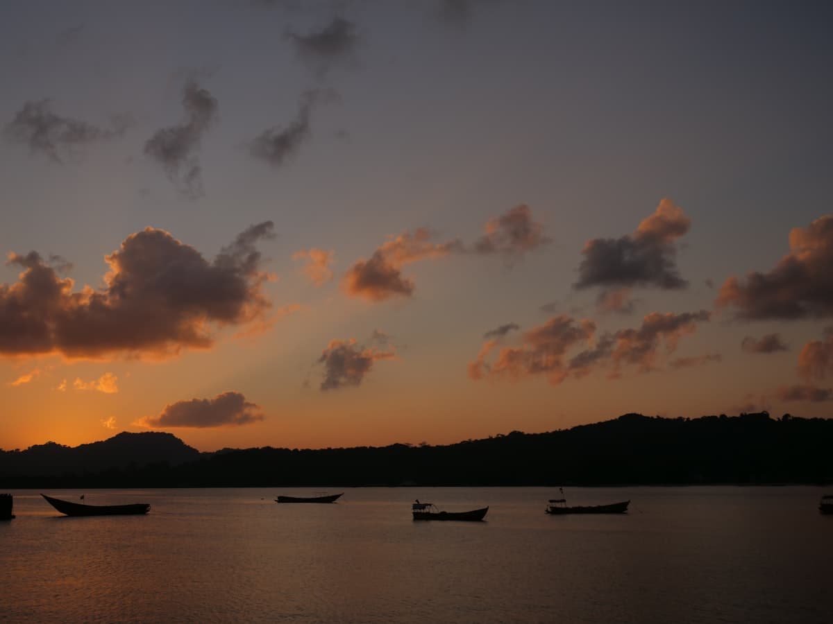 Small boats floating on calm open water under a cloudy sky, Andaman and Nicobar Islands