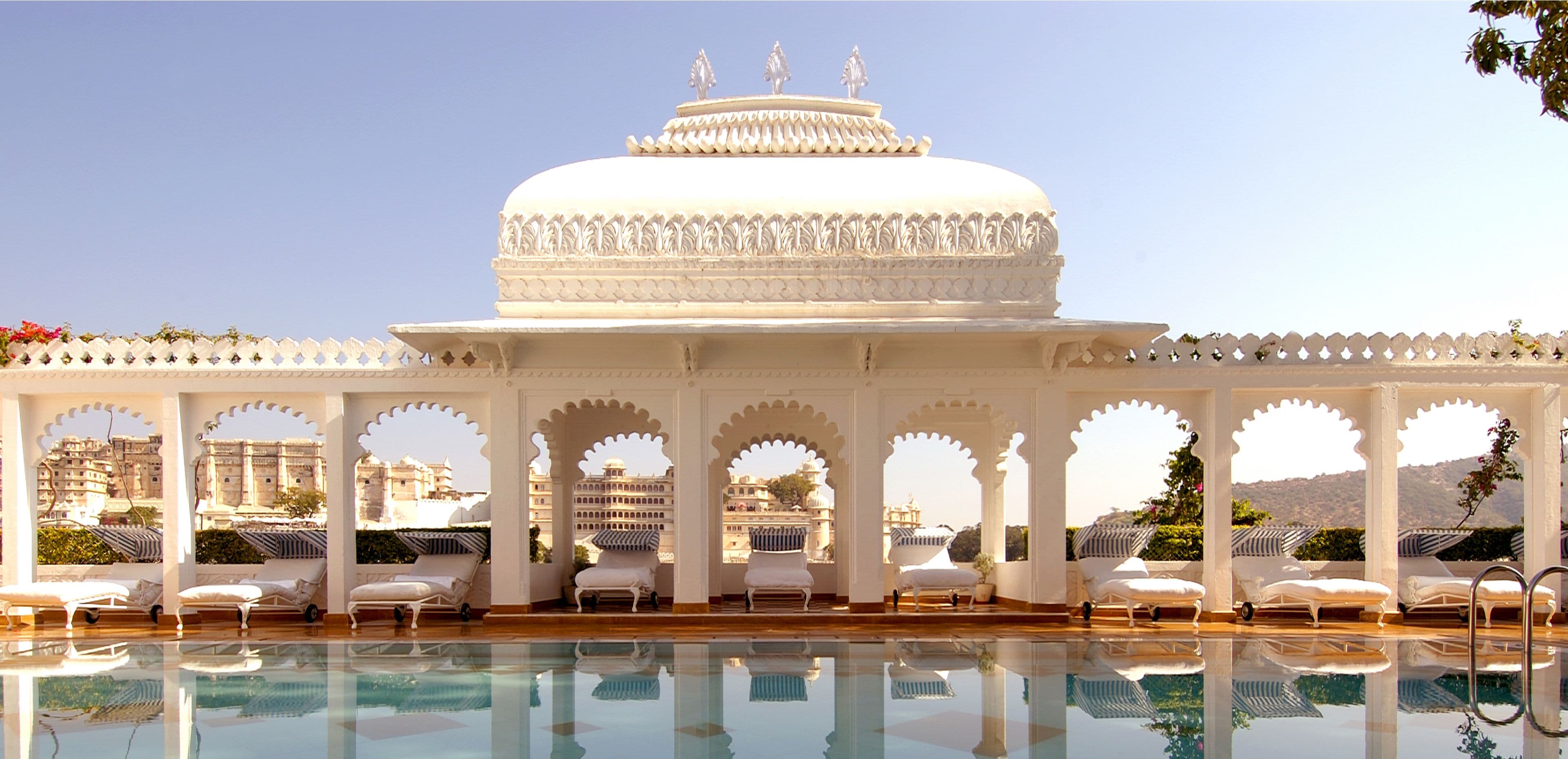 Taj Lake Palace seen from the water, its white marble facade spanning its island on Lake Pichola