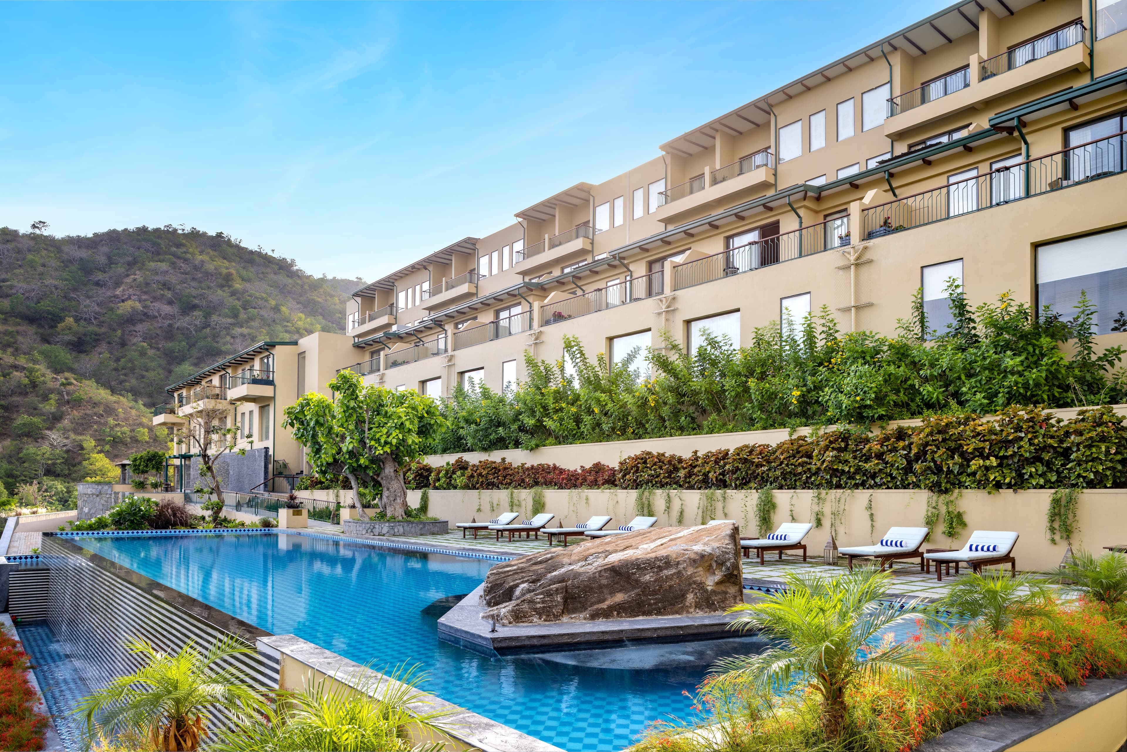 The stone exterior of Radisson Blu Resort Kumbhalgarh stepping down its hillside in the Aravalli range