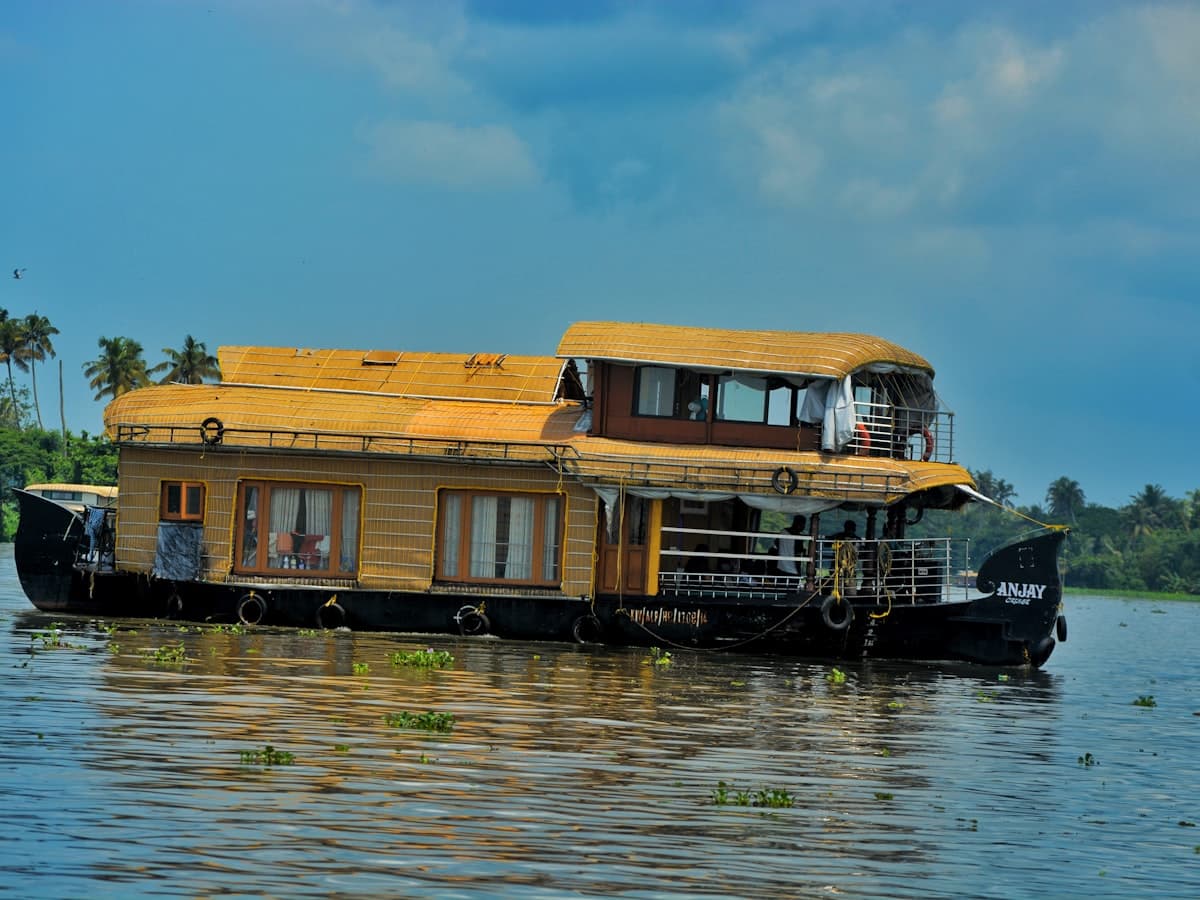 A houseboat drifting on still backwater under an early morning sky