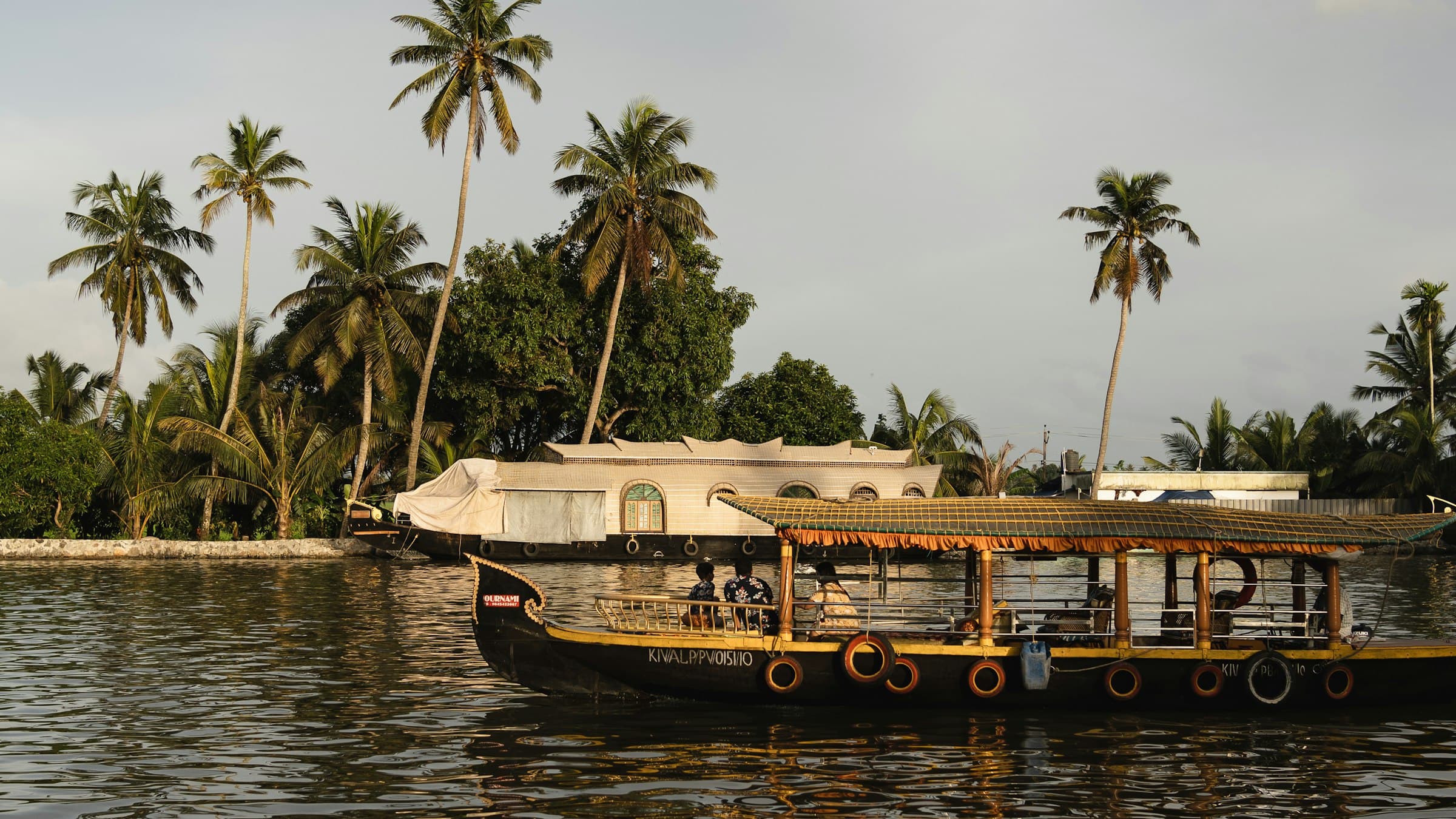 A boat out on the water with Vembanad Lake stretching away behind it
