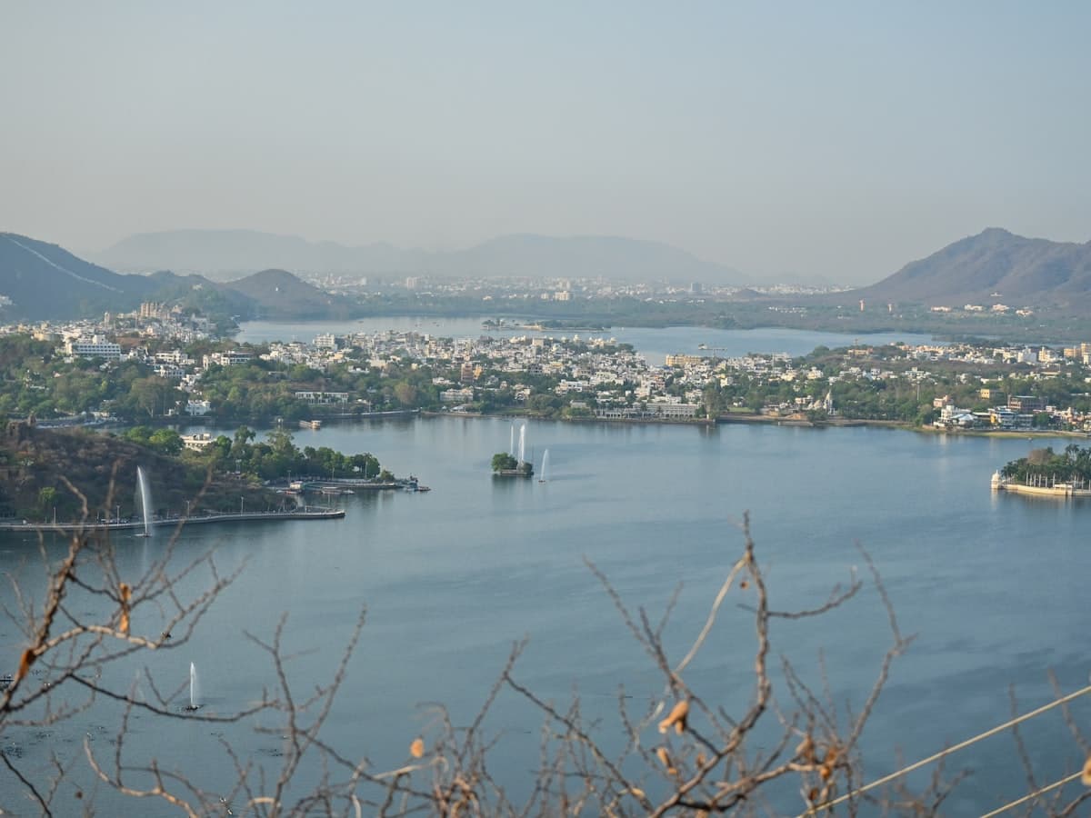 A body of water surrounded by mountains and a city