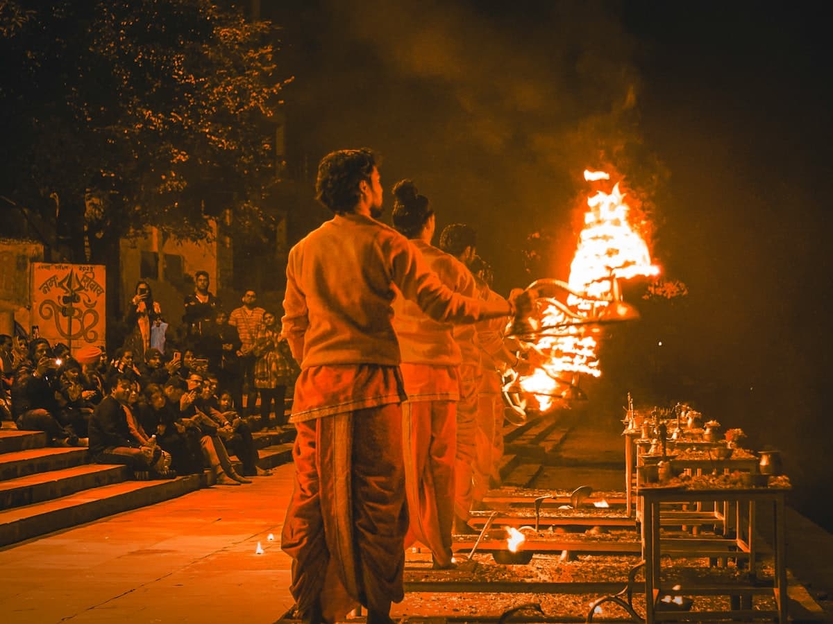 People standing in front of a ceremonial fire