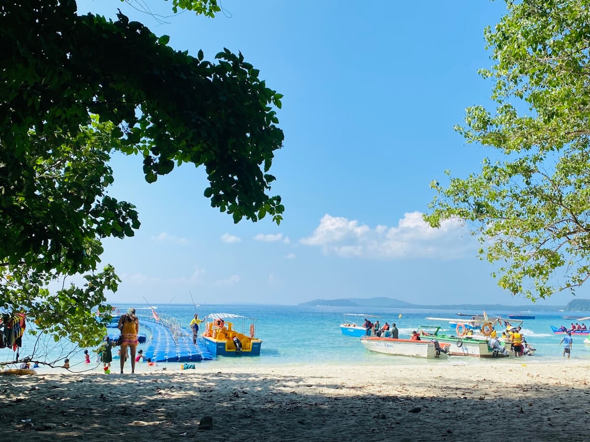 Visitors on a wide sandy beach on Havelock Island, Andaman Islands