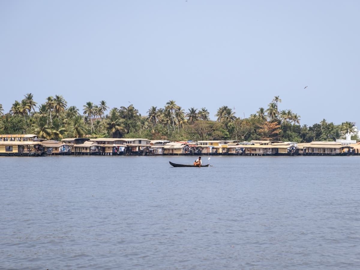 A body of water with a boat out in the middle of it