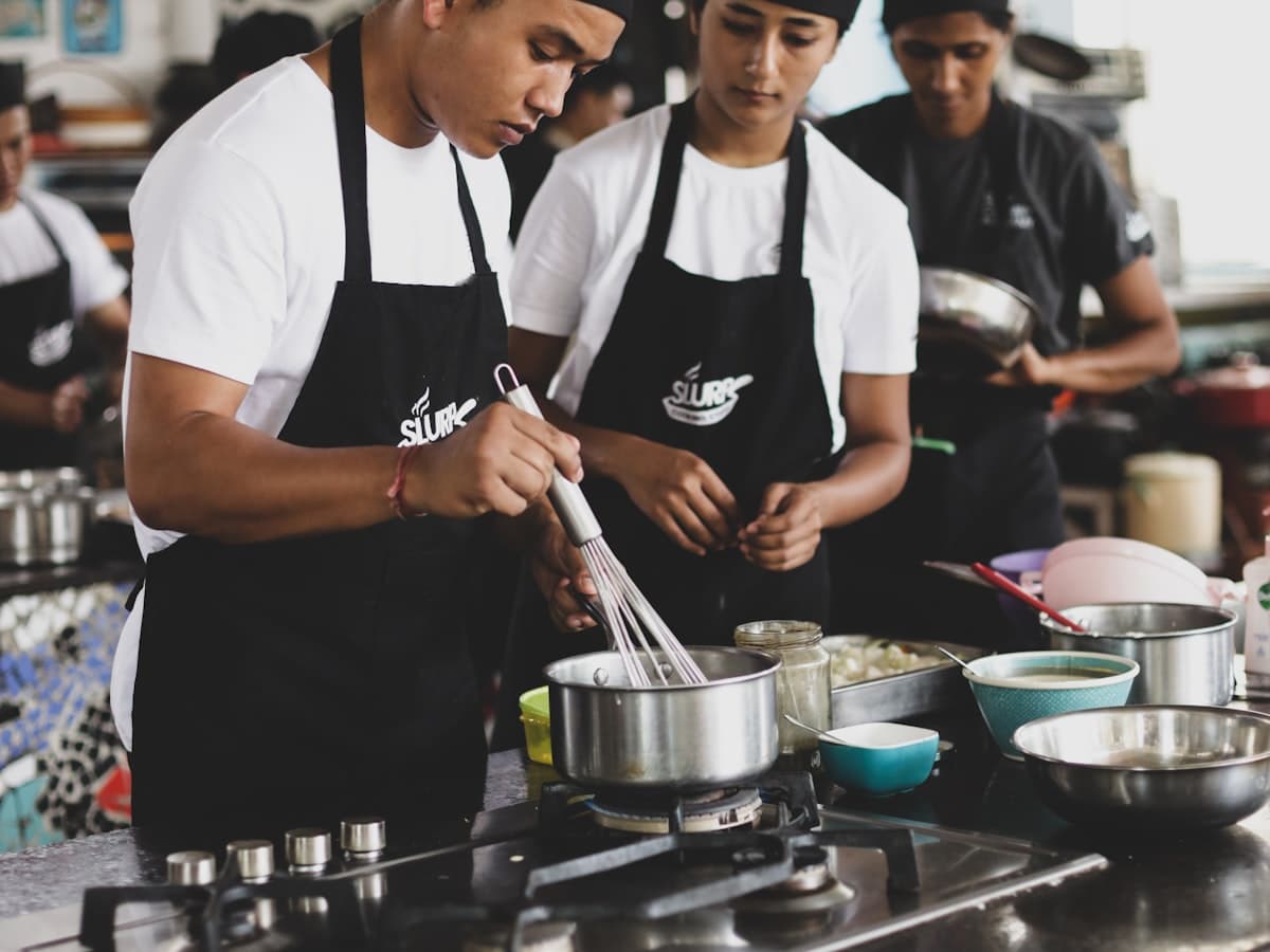 A group of people cooking together in a kitchen